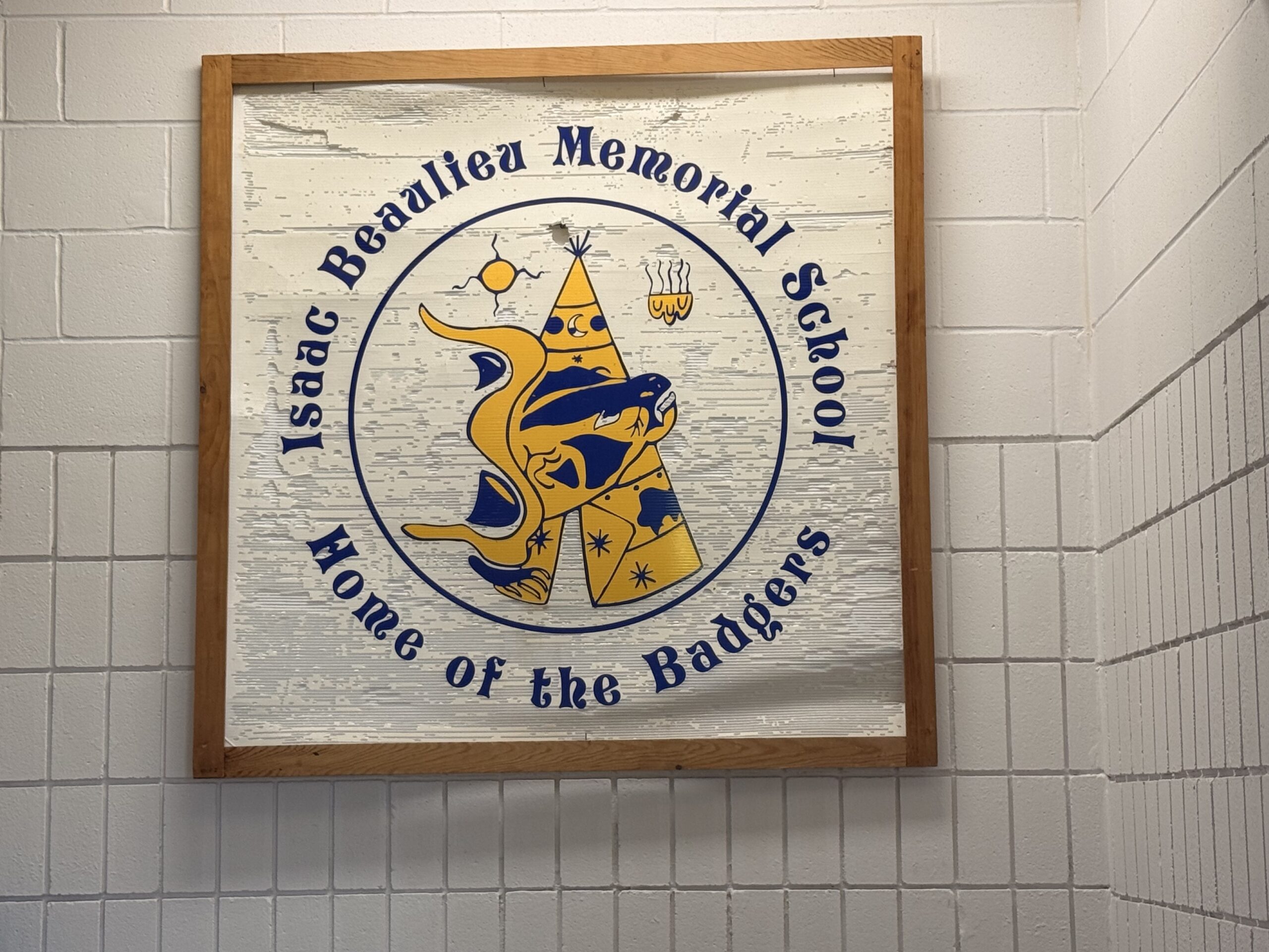 Isaac Beaulieu Memorial School logo with slogan "Home of the Badgers" sign.